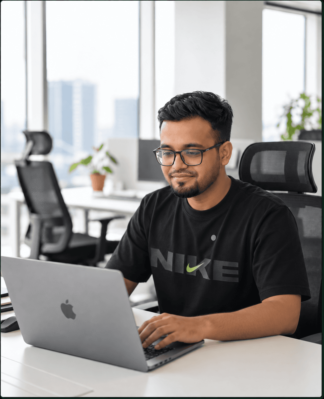 Md Hasibuzzaman working on a MacBook in an office
